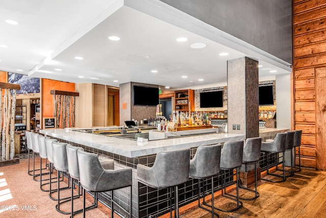 bar with light hardwood / wood-style flooring