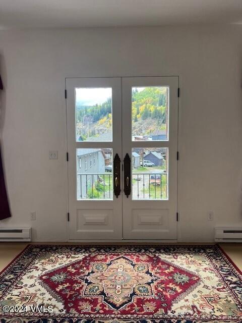 doorway to outside featuring french doors and a baseboard radiator