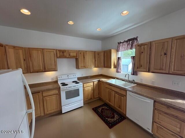 kitchen featuring white appliances and sink