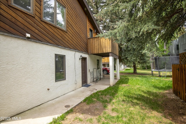 83 Larkspur Ln Unit A, Avon, CO 81620 - view of grassy yard featuring a trampoline and a balcony