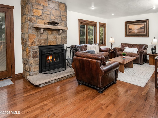 83 Larkspur Ln Unit A, Avon, CO 81620 - living area with wood finished floors, a stone fireplace, and recessed lighting