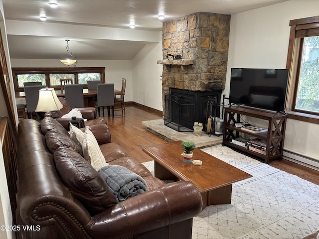 83 Larkspur Ln Unit A, Avon, CO 81620 - living room featuring wood finished floors and a stone fireplace