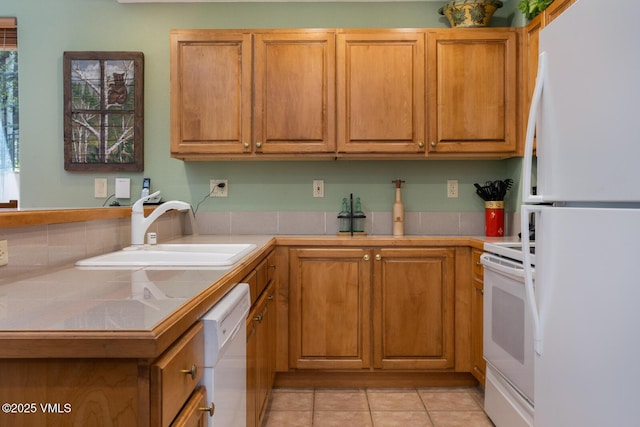 74 Cresta Rd Unit 110, Edwards, CO 81632 - kitchen featuring white appliances, tile countertops, light tile patterned flooring, and brown cabinetry