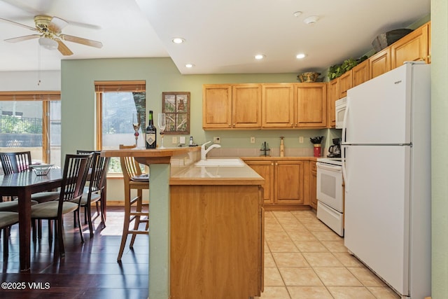 74 Cresta Rd Unit 110, Edwards, CO 81632 - kitchen with white appliances, a peninsula, ceiling fan, recessed lighting, and light countertops