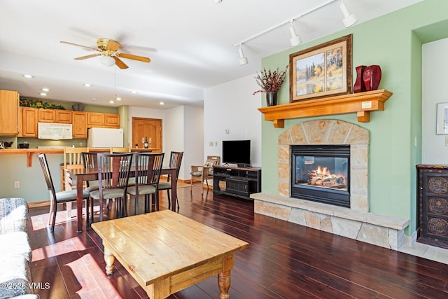 74 Cresta Rd Unit 110, Edwards, CO 81632 - living room featuring dark wood-style floors, track lighting, a ceiling fan, a stone fireplace, and recessed lighting