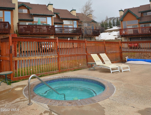 view of pool featuring a patio area, a hot tub, and fence