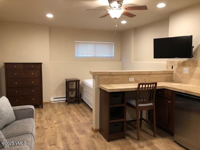 office area with a baseboard radiator, recessed lighting, light wood-type flooring, and ceiling fan