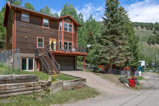 445 Pine St, Red Cliff, CO 81649 - view of front facade with driveway, a deck, a garage, and stairway