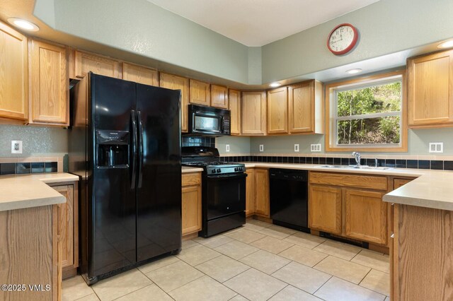 445 Pine St, Red Cliff, CO 81649 - kitchen with black appliances, light tile patterned flooring, light countertops, backsplash, and light brown cabinets