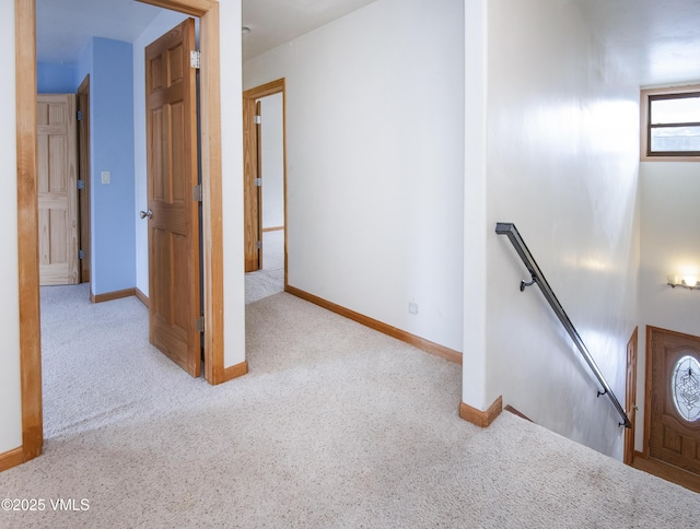 corridor featuring light colored carpet