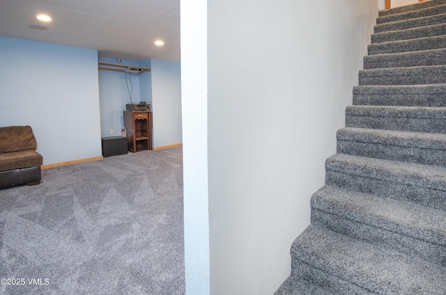 staircase featuring carpet