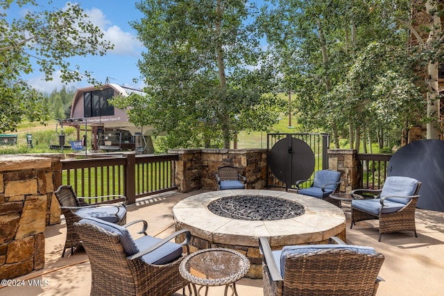 view of patio featuring a grill and an outdoor fire pit