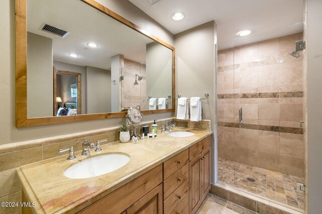 bathroom with walk in shower and vanity