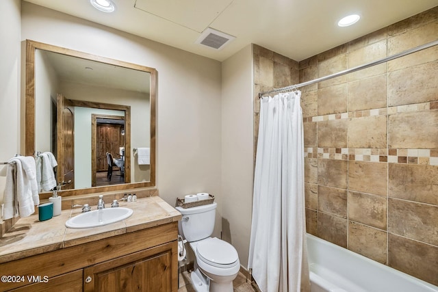 full bathroom featuring vanity, shower / bath combo with shower curtain, and toilet