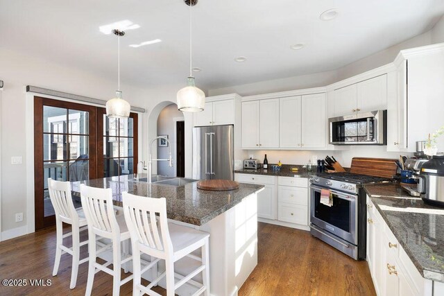 50 Bunker Way, Eagle, CO 81631 - kitchen with dark wood finished floors, a sink, arched walkways, and appliances with stainless steel finishes