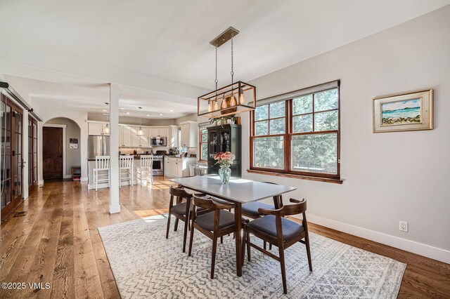 50 Bunker Way, Eagle, CO 81631 - dining area featuring light wood finished floors, baseboards, arched walkways, and recessed lighting