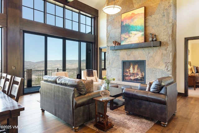 620 Jouflas Ranch Rd, Wolcott, CO 81655 - living area featuring a high ceiling, a mountain view, hardwood / wood-style flooring, and a fireplace