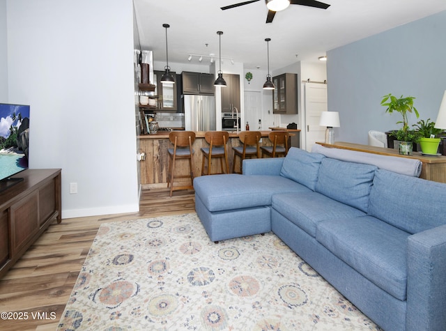 175 Hurd Ln Unit 3101, Avon, CO 81620 - living room with light wood-type flooring, a ceiling fan, baseboards, and track lighting