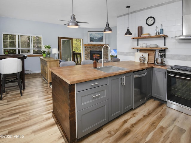 175 Hurd Ln Unit 3101, Avon, CO 81620 - kitchen with gas stove, stainless steel dishwasher, a sink, wood counters, and gray cabinetry