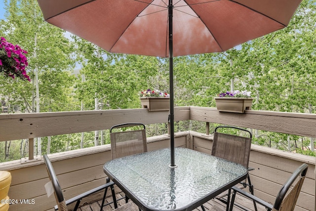 411 Eagle Dr Unit 10, Eagle-Vail, CO 81620 - deck with outdoor dining space and view of wooded area