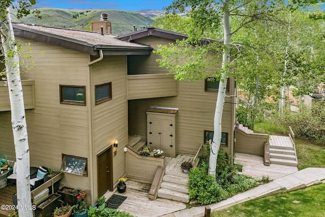 411 Eagle Dr Unit 10, Eagle-Vail, CO 81620 - rear view of house with a mountain view and a chimney