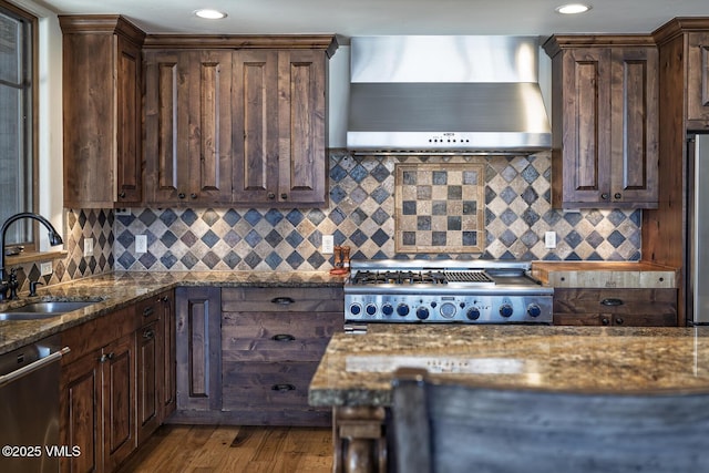 93 S Penstemon Ln, Eagle, CO 81631 - kitchen with wall chimney exhaust hood, appliances with stainless steel finishes, dark brown cabinets, and a sink