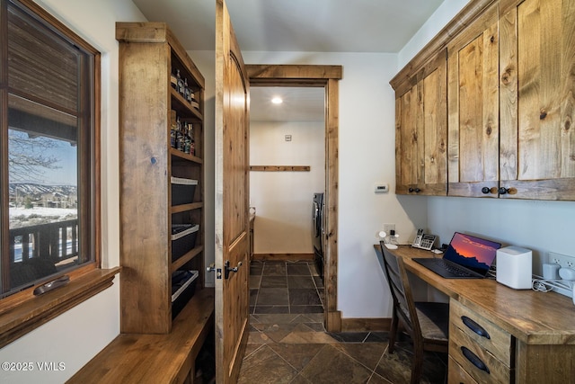 93 S Penstemon Ln, Eagle, CO 81631 - interior space featuring built in desk, stone finish flooring, and baseboards