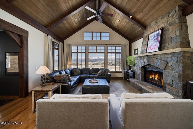 93 S Penstemon Ln, Eagle, CO 81631 - living area featuring hardwood / wood-style flooring, wood ceiling, beam ceiling, and a stone fireplace