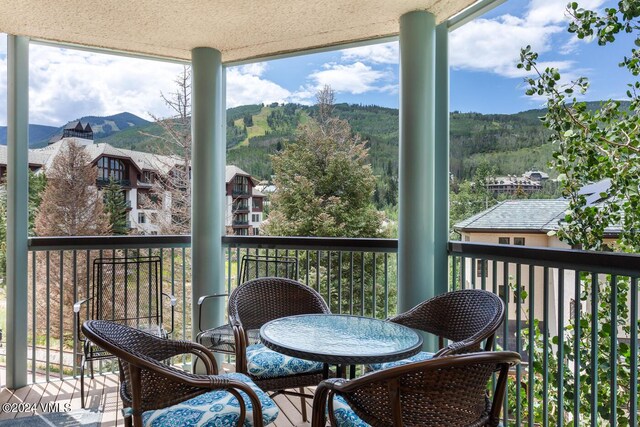 sunroom with a mountain view and a wealth of natural light