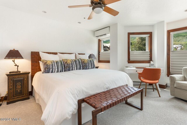 carpeted bedroom featuring ceiling fan, a wall mounted AC, and multiple windows