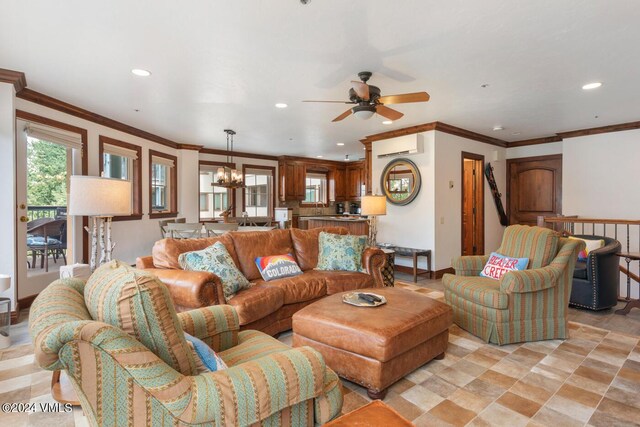 living room with ornamental molding, a wall mounted AC, and ceiling fan with notable chandelier