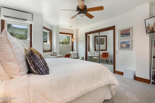 bedroom featuring carpet floors, a wall mounted AC, ceiling fan, and a closet