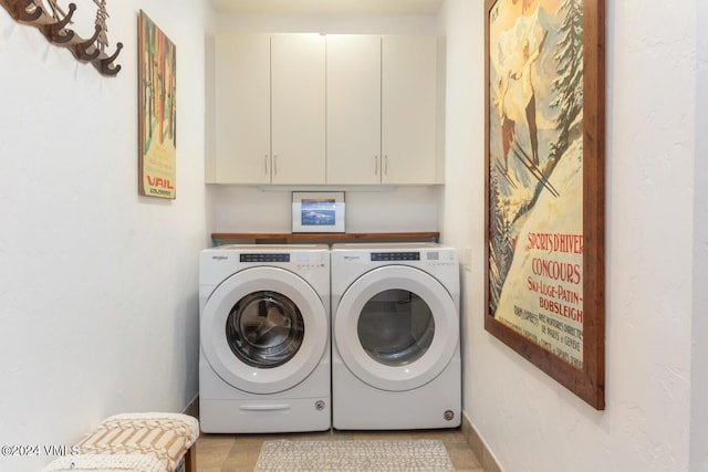 laundry area featuring cabinets and washing machine and clothes dryer