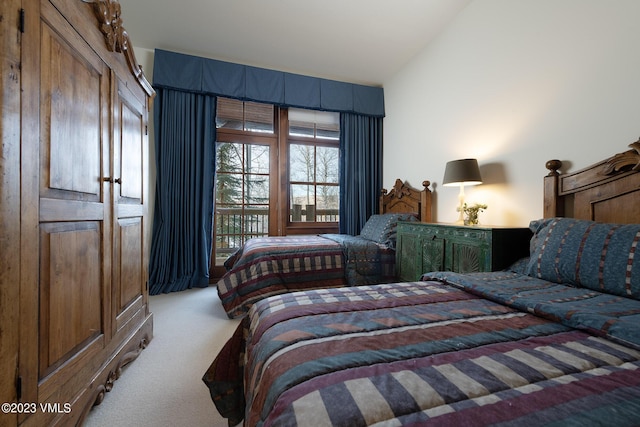 bedroom with access to exterior, carpet flooring, and vaulted ceiling