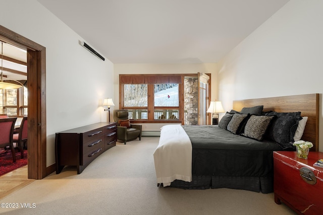 bedroom featuring light colored carpet and a baseboard radiator