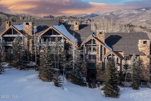 view of front facade featuring a mountain view and a chimney