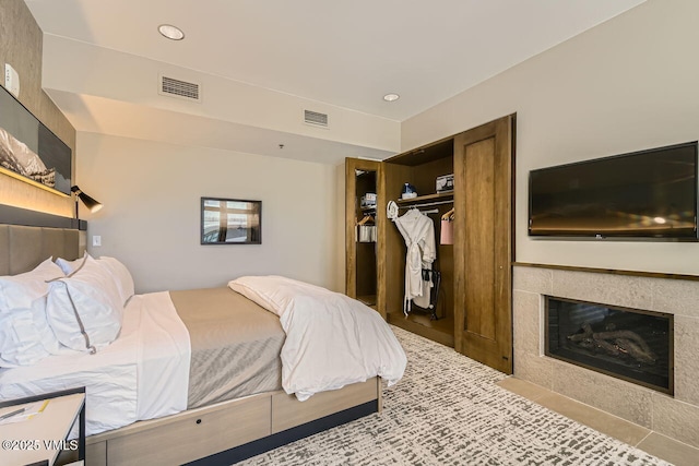 126 Riverfront Ln Unit 438, Avon, CO 81620 - tiled bedroom with a closet, recessed lighting, and a tiled fireplace
