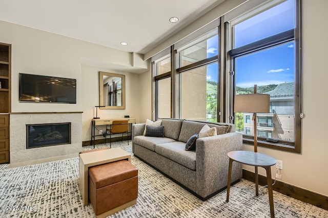 126 Riverfront Ln Unit 438, Avon, CO 81620 - living area with a high end fireplace, baseboards, and recessed lighting