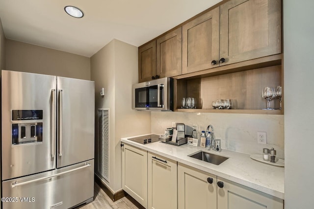 126 Riverfront Ln Unit 438, Avon, CO 81620 - kitchen with appliances with stainless steel finishes, a sink, light stone countertops, light wood-style floors, and open shelves