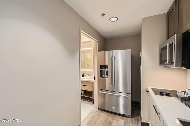 126 Riverfront Ln Unit 438, Avon, CO 81620 - kitchen with appliances with stainless steel finishes, light wood-style floors, and a sink