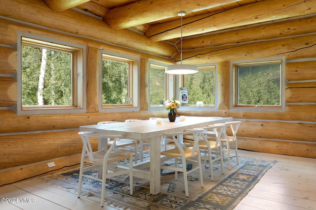 sunroom with a wealth of natural light and beamed ceiling