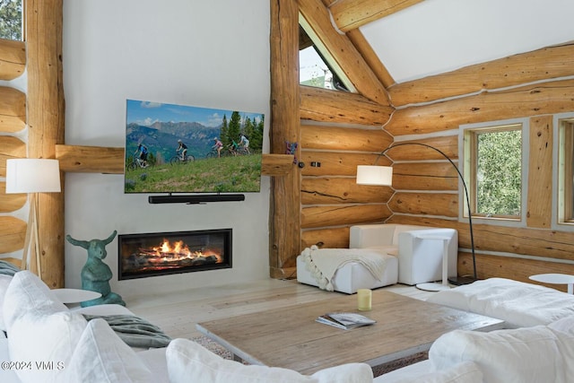 living room featuring wood-type flooring, vaulted ceiling with beams, and log walls