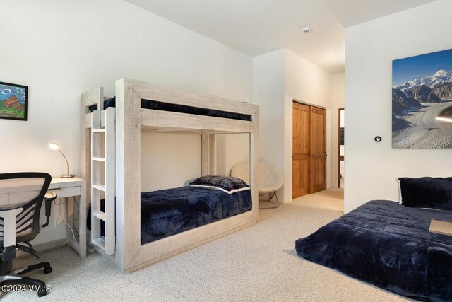 bedroom featuring light colored carpet