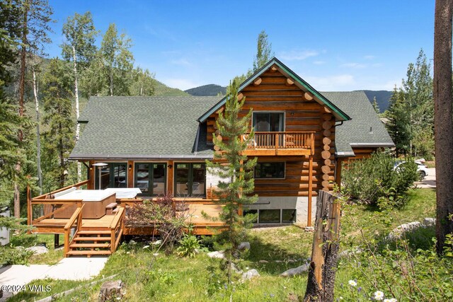 rear view of property with a deck with mountain view