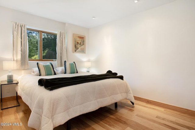 bedroom with wood-type flooring