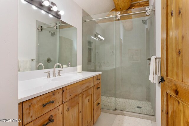 bathroom with vanity and a shower with door