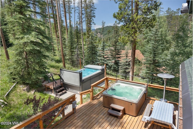 2219 Vermont Ct, Vail, CO 81657 - wooden terrace with a hot tub and a view of trees