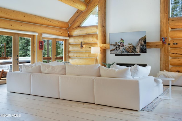 2219 Vermont Ct, Vail, CO 81657 - living room featuring rustic walls, healthy amount of natural light, french doors, beam ceiling, and hardwood / wood-style floors