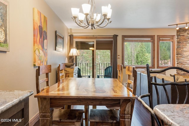 dining area with hardwood / wood-style flooring and a chandelier