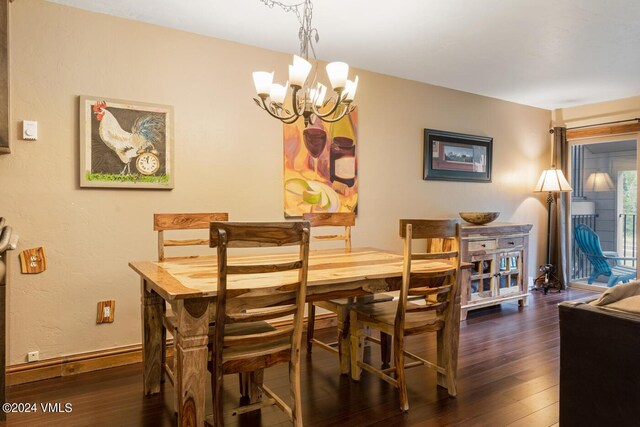 dining space featuring a chandelier and dark hardwood / wood-style flooring